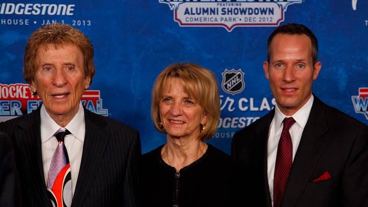 Feb. 9, 2012; Ann Arbor, MI, USA; Detroit Red Wings owner Mike Illitch (left), wife Marian Illitch (center), and son Chris Illitch during NHL press conference for the 2013 Winter Classic between Detroit Red Wings and Toronto Maple Leafs at Michigan Stadium. Mandatory Credit: Rick Osentoski-USA TODAY Sports