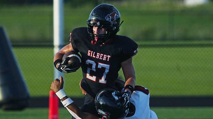 Gilbert running back Micah Leyva (27) battles for a few yard as getting tackle by Mason City linebacker Parker Sgontz (8) during the first quarter in the week-2 Iowa high school football at Tiger Stadium on Sept. 4, 2026, in Gilbert, Iowa. Gilbert running back Micah Leyva (27) battles for a few yard as getting tackle by Mason City linebacker Parker Sgontz (8) during the first quarter in the week-2 Iowa high school football at Tiger Stadium on Sept. 4, 2026, in Gilbert, Iowa.