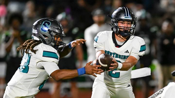 Southside quarterback Parker Dies hands off to Justin Williams