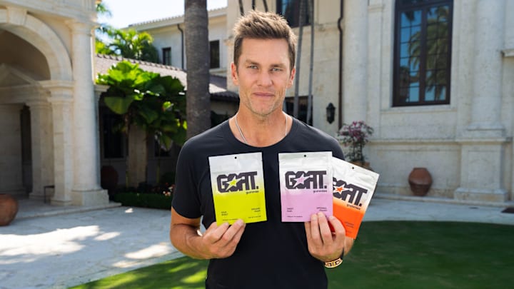 Tom Brady holds all three flavors of the new GOAT Gummies