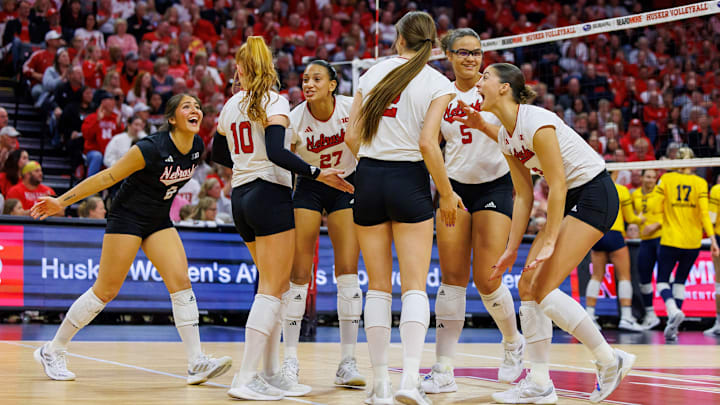 Nebraska volleyball players celebrate a point against Michigan. Nebraska volleyball players celebrate a point against Michigan.