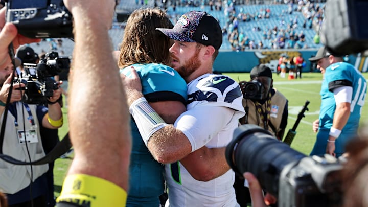 Oct 12, 2025; Jacksonville, Florida, USA; Jacksonville Jaguars quarterback Trevor Lawrence (16) and Seattle Seahawks quarterback Sam Darnold (14) react after the game at EverBank Stadium. 