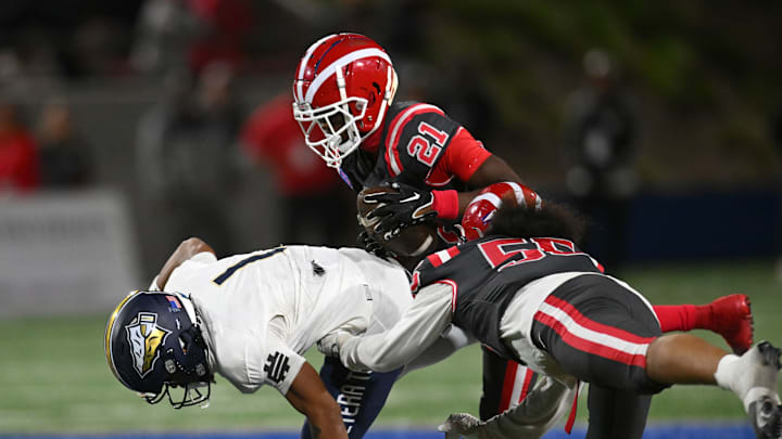 Mater Dei sophomore Aaryn Washington (21) with a spectacular interception that he brought back 45 yards for a touchdown in the second quarter of a 59-14 win over St. John Bosco at Santa Ana Stadium. 