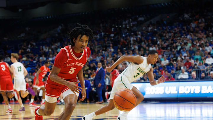 Junior Bruin guard Elijah Garrett chases down a loose ball in the first quarter of the UIL Texas 5A Division I basketball state championship and races to the other end for a fast break layup.