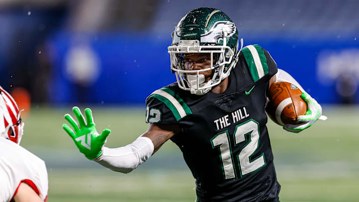 Travis Hunter prepares to stiff-arm a Milton defender during Collins Hill's Georgia high school state championship win in 2021. Travis Hunter prepares to stiff-arm a Milton defender during Collins Hill's Georgia high school state championship win in 2021.