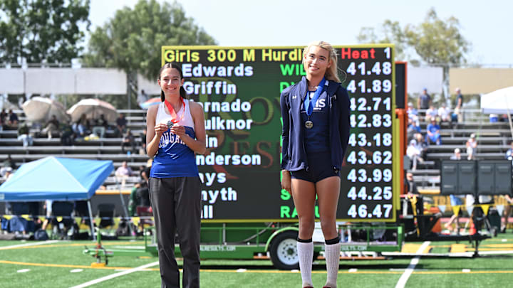 Jurupa Valley's AB Hernandez (right) stands on the No. 1 mark of the winner's podium after winning the triple jump at the CIF Masters meet whilst Kaylee Best of Norco stands on the No. 2 spot.