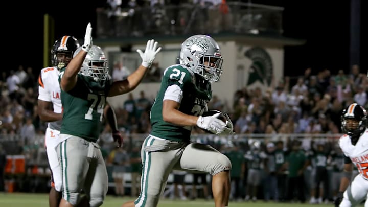 Duece Jones-Drew (21) goes in for winning touchdown with 2:40 remaining in De La Salle's gritty 10-6 home win over Lakeland (Fla.) Aug. 29 in Concord (Calif.). Spartans win 12th straight game and 33rd straight NCS title with 24-17 victory over Pittsburg on Nov. 21.