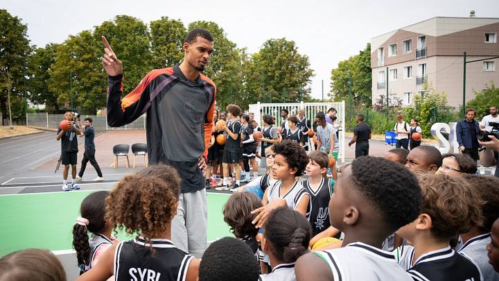 July 30, 2026; Nanterre, France; San Antonio Spurs forward Victor Wembanyama (1) speaks to a group of children during a refurbished community basketball court unveiling event. July 30, 2026; Nanterre, France; San Antonio Spurs forward Victor Wembanyama (1) speaks to a group of children during a refurbished community basketball court unveiling event.