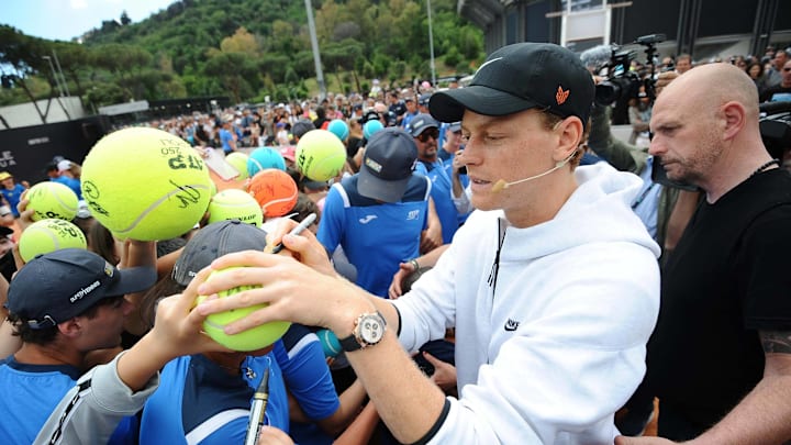 Jannik Sinner signs autographs for fans at the Italian Open.