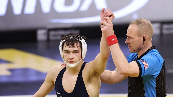 Penn State Nittany Lions wrestler Luke Lilledahl gets his hand raised after a win over Iowa Hawkeyes' Dean Peterson at Carver-Hawkeye Arena. 