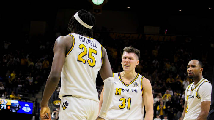 Jan 11, 2025; Columbia, Missouri, USA; Missouri Tigers guards Caleb Grill (31) and Tamar Bates (2) celebrate with forward Mark Mitchell (25)  during a game against the Vanderbilt Commodores at Mizzou Arena. 