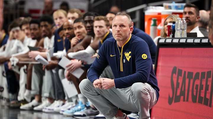 Mar 12, 2025; Kansas City, MO, USA; West Virginia Mountaineers coach Darian DeVries watches game play during the first half against the Colorado Buffaloes at T-Mobile Center. Mandatory Credit: William Purnell-Imagn Images