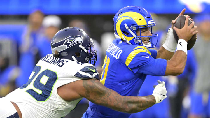 Jan 5, 2025; Inglewood, California, USA; Los Angeles Rams quarterback Jimmy Garoppolo (11) is sacked by Seattle Seahawks defensive end Leonard Williams (99) in the second half at SoFi Stadium. Mandatory Credit: Jayne Kamin-Oncea-Imagn Images