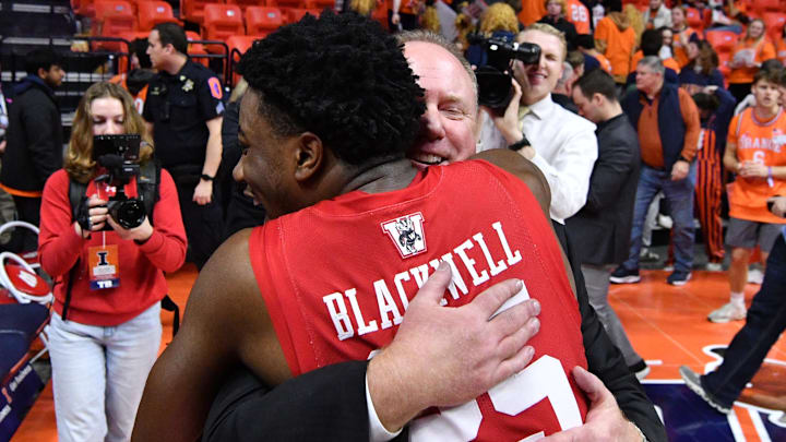 Feb 10, 2026; Champaign, Illinois, USA;  Wisconsin Badgers head coach Greg Gard hugs player John Blackwell (25) after a win over the Illinois Fighting Illini at State Farm Center. 