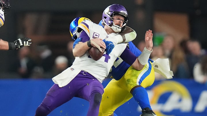 Los Angeles Rams defensive lineman Neville Gallimore (92) sacks Minnesota Vikings quarterback Sam Darnold (14) during their playoff game at State Farm Stadium on Jan. 13, 2025, in Glendale. The Rams beat the Vikings, 27-9. Los Angeles Rams defensive lineman Neville Gallimore (92) sacks Minnesota Vikings quarterback Sam Darnold (14) during their playoff game at State Farm Stadium on Jan. 13, 2025, in Glendale. The Rams beat the Vikings, 27-9.
