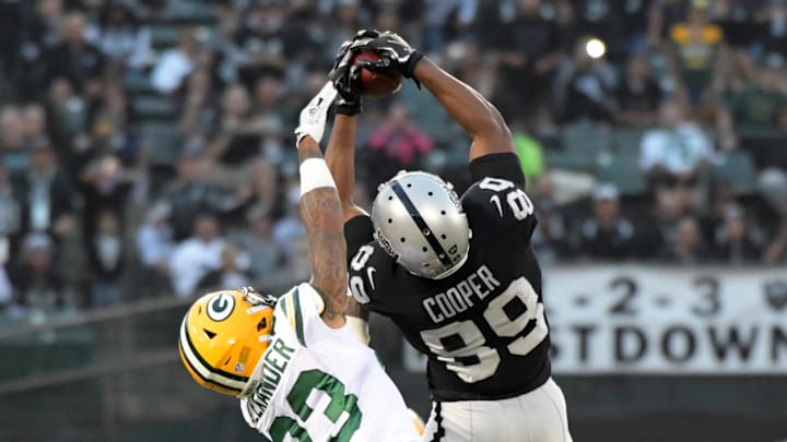 Aug 24, 2018; Oakland, CA, USA; Oakland Raiders wide receiver Amari Cooper (89) hauls in a catch in front of Green Bay Packers cornerback Jaire Alexander (23) in the first quarter during a preseason game at Oakland-Alameda County Coliseum. Mandatory Credit: Kirby Lee-Imagn Images