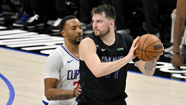  Dallas Mavericks guard Luka Doncic (77) looks to move the ball past LA Clippers guard Norman Powell (24) during the fourth quarter during game six of the first round for the 2024 NBA playoffs at American Airlines Center. Mandatory Credit: Jerome Miron-Imagn Images