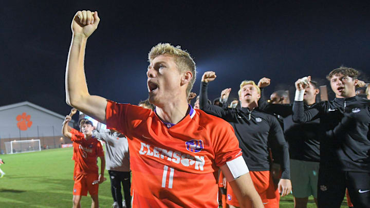 Clemson midfielder Brandon Parrish celebrates with the team and fans.