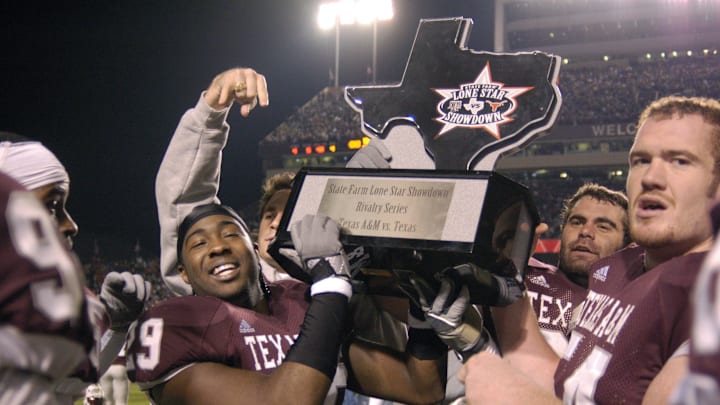 Texas A&M Aggies defensive back Stephen Hodge (29) and offensive lineman Corey Clark (54) celebrate after the game with the Lone Star Showdown trophy against the Texas Longhorns at Kyle Field. 