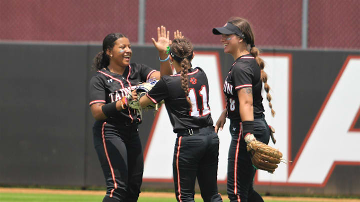 Taunton outfielders Kyleah Plumb (left), Mia Torres (center) and Ava Venturelli (right) hi-five ahead of the start of an inning during the 2023 MIAA Division I Softball championship game against Central Catholic.