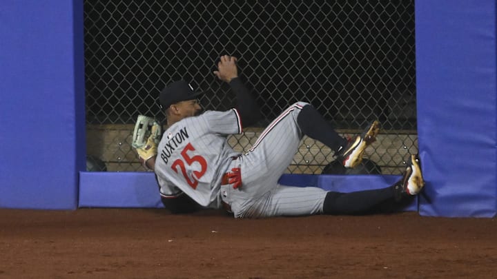 Apr 29, 2025; Cleveland, Ohio, USA; Minnesota Twins center fielder Byron Buxton (25) makes contact with the outfield wall after making a sliding catch in the third inning against the Cleveland Guardians at Progressive Field. Mandatory Credit: David Richard-Imagn Images
