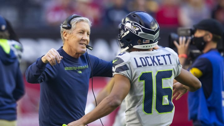 Jan 9, 2022; Glendale, Arizona, USA; Seattle Seahawks head coach Pete Carroll (left) hugs wide receiver Tyler Lockett (16) prior to the game against the Arizona Cardinals at State Farm Stadium. Mandatory Credit: Mark J. Rebilas-Imagn Images