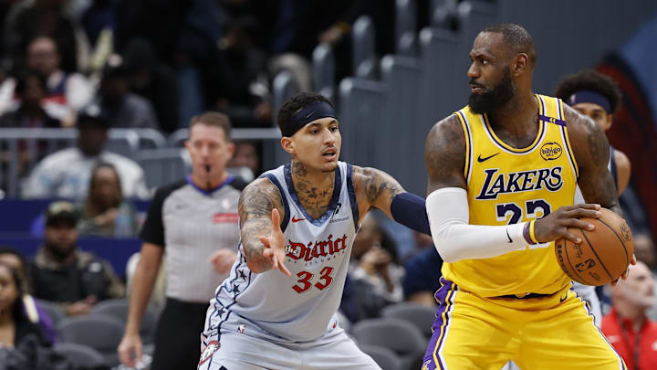 Jan 30, 2025; Washington, District of Columbia, USA; Los Angeles Lakers forward LeBron James (23) holds the ball as Washington Wizards forward Kyle Kuzma (33) defends in the third quarter at Capital One Arena. Mandatory Credit: Geoff Burke-Imagn Images