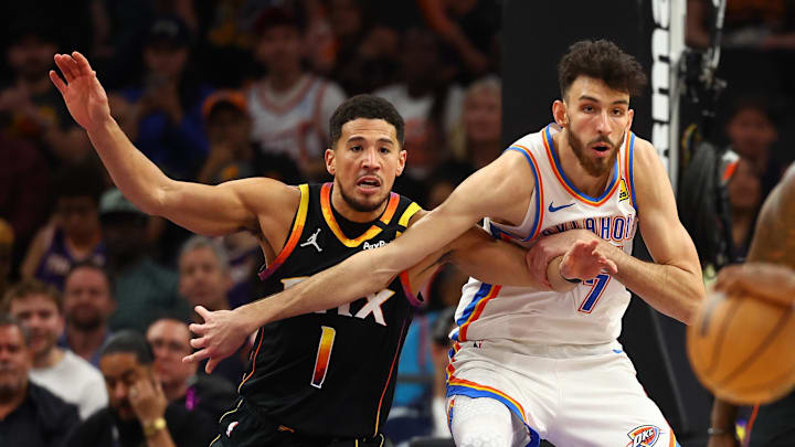 Apr 9, 2025; Phoenix, Arizona, USA; Phoenix Suns guard Devin Booker (1) and Oklahoma City Thunder forward Chet Holmgren (7) push for position during the first half at Footprint Center. Mandatory Credit: Mark J. Rebilas-Imagn Images