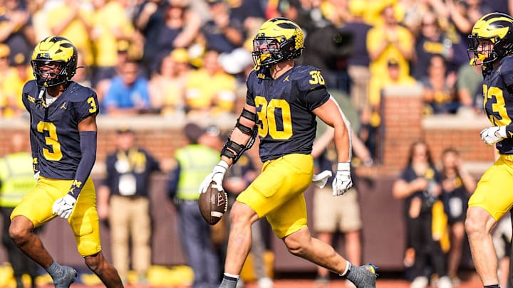 Michigan linebacker Jimmy Rolder (30) celebrates an interception against Washington during the second half at Michigan Stadium in Ann Arbor on Saturday, Oct. 18, 2025. Michigan linebacker Jimmy Rolder (30) celebrates an interception against Washington during the second half at Michigan Stadium in Ann Arbor on Saturday, Oct. 18, 2025.