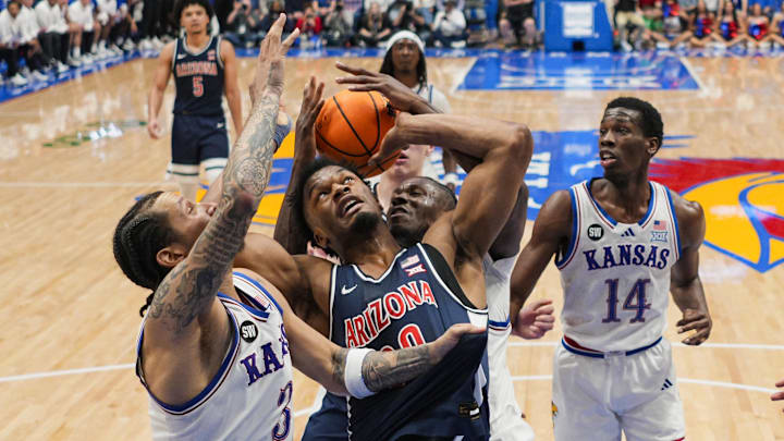 Feb 9, 2026; Lawrence, Kansas, USA; Arizona Wildcats forward Tobe Awaka (30) fights for a rebound against the Kansas Jayhawks during the second half at Allen Fieldhouse. Mandatory Credit: Jay Biggerstaff-Imagn Images