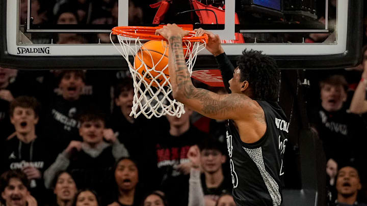 Cincinnati Bearcats forward Dillon Mitchell (23) dunks in the first half of the 92nd Annual Crosstown Shootout NCAA basketball game between the Cincinnati Bearcats and the Xavier Musketeers at Fifth Third Arena on the UC campus in Cincinnati on Saturday, Dec. 14, 2024. Xavier led 31-30 at halftime. Cincinnati Bearcats forward Dillon Mitchell (23) dunks in the first half of the 92nd Annual Crosstown Shootout NCAA basketball game between the Cincinnati Bearcats and the Xavier Musketeers at Fifth Third Arena on the UC campus in Cincinnati on Saturday, Dec. 14, 2024. Xavier led 31-30 at halftime.