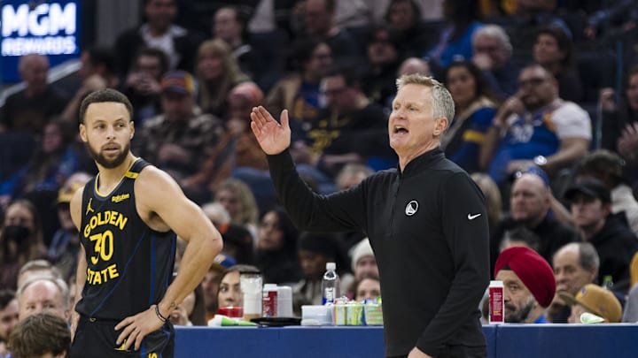 Dec 30, 2024; San Francisco, California, USA;  Golden State Warriors guard Stephen Curry (30) watches as head coach Steve Kerr reacts during the first quarter of the game against the Cleveland Cavaliers against the Cleveland Cavaliers at Chase Center. Mandatory Credit: John Hefti-Imagn Images