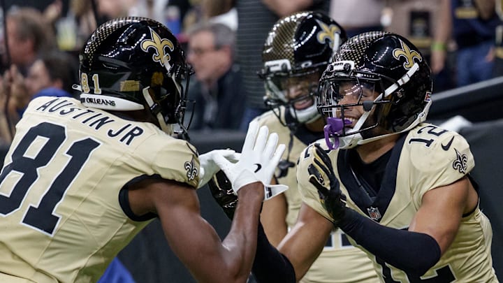 Dec 21, 2025; New Orleans, Louisiana, USA; New Orleans Saints wide receiver Chris Olave (12) celebrates a touchdown against the New York Jets with New Orleans Saints wide receiver Kevin Austin Jr. (81) during the third quarter at Caesars Superdome. Mandatory Credit: Matthew Hinton-Imagn Images