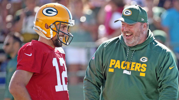 Green Bay Packers quarterback Aaron Rodgers talks with head coach Mike McCarthy