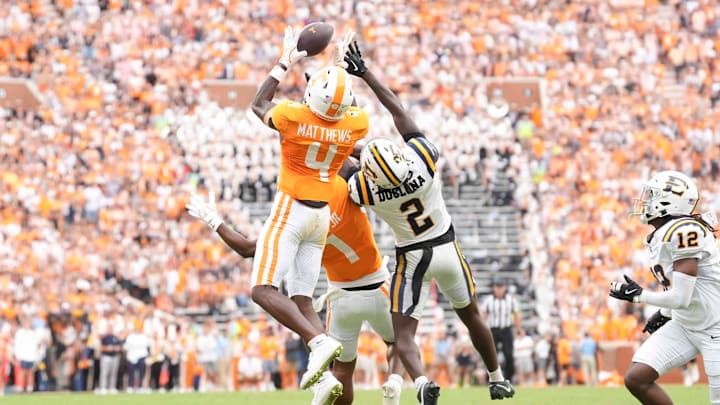 Tennessee wide receiver Mike Matthews (4) makes a catch before running into the end zone for a touchdown, while defended by ETSU defensive back Jason Duclona (2) during a college football game between Tennessee and ETSU at Neyland Stadium in Knoxville, Tennessee, on August 30, 2025.