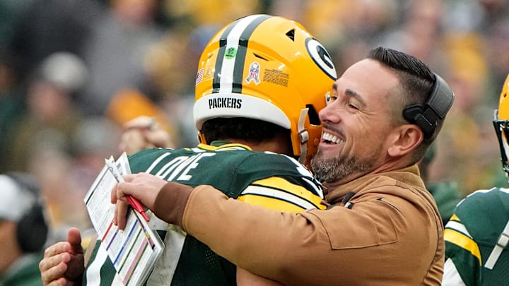 Green Bay Packers quarterback Jordan Love (10) is hugged by head coach Matt LaFleur after throwing a