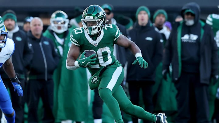 Dec 22, 2024; East Rutherford, New Jersey, USA; New York Jets running back Breece Hall (20) runs with the ball against the Los Angeles Rams during the third quarter at MetLife Stadium. 