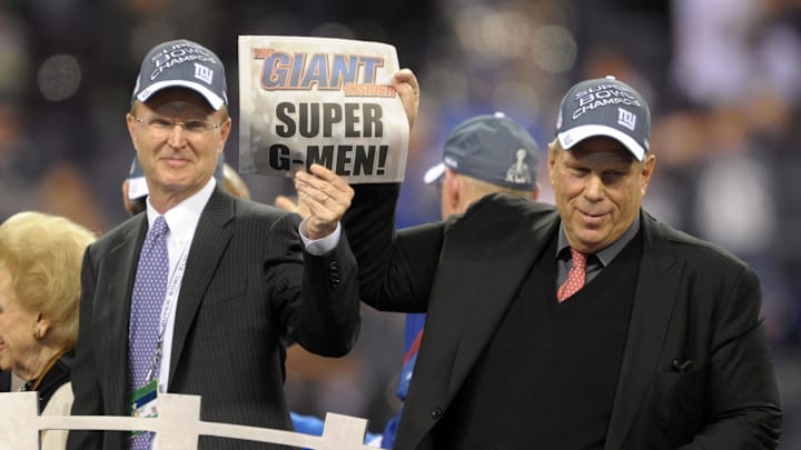 New York Giants co-owners John Mara (left) and Steve Tisch hold a newspaper after Super Bowl XLVI against the New England Patriots at Lucas Oil Stadium. 