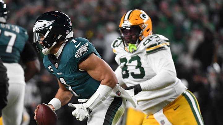 Jan 12, 2025; Philadelphia, Pennsylvania, USA; Philadelphia Eagles quarterback Jalen Hurts (1) avoids the pressure of Green Bay Packers defensive tackle T.J. Slaton (93) during the first half in an NFC wild card game at Lincoln Financial Field. Mandatory Credit: Eric Hartline-Imagn Images Jan 12, 2025; Philadelphia, Pennsylvania, USA; Philadelphia Eagles quarterback Jalen Hurts (1) avoids the pressure of Green Bay Packers defensive tackle T.J. Slaton (93) during the first half in an NFC wild card game at Lincoln Financial Field. Mandatory Credit: Eric Hartline-Imagn Images