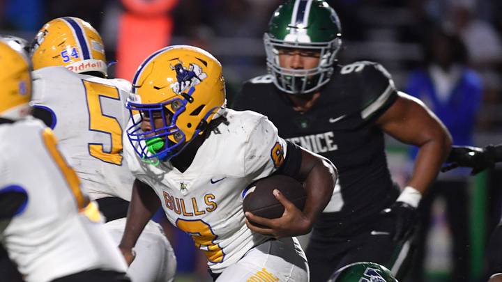 Miami Northwestern ball carrier Elijah Hardy (#8) follows his blockers through a hole in the Venice defensive line. The Venice High Indians hosted the Miami Northwestern Bulls in a non-conference game Friday evening, Aug. 30, 2024. Miami Northwestern ball carrier Elijah Hardy (#8) follows his blockers through a hole in the Venice defensive line. The Venice High Indians hosted the Miami Northwestern Bulls in a non-conference game Friday evening, Aug. 30, 2024.