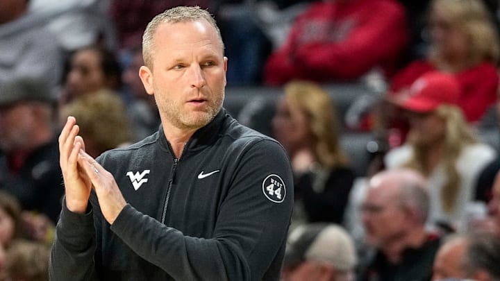 West Virginia Mountaineers head coach Darian DeVries applauds his defense in the first half of the NCAA basketball game between the Cincinnati Bearcats and the West Virginia Mountaineers at Fifth Third Arena in Cincinnati on Sunday, Feb. 2, 2025.