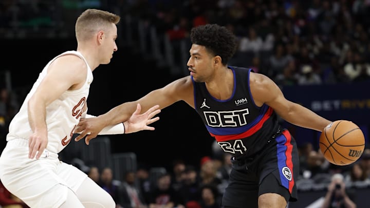Mar 1, 2024; Detroit, Michigan, USA;  Detroit Pistons guard Quentin Grimes (24) dribbles against Cleveland Cavaliers guard Sam Merrill (5) in the first half at Little Caesars Arena. Mandatory Credit: Rick Osentoski-Imagn Images
