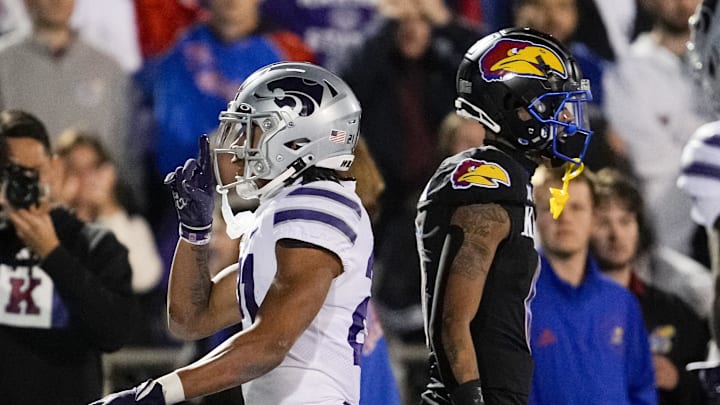Nov 18, 2023; Lawrence, Kansas, USA; Kansas State Wildcats safety Marques Sigle (21) gestures to the crowd after intercepting a pass intended for Kansas Jayhawks wide receiver Quentin Skinner (0) during the second half at David Booth Kansas Memorial Stadium. Mandatory Credit: Jay Biggerstaff-USA TODAY Sports Nov 18, 2023; Lawrence, Kansas, USA; Kansas State Wildcats safety Marques Sigle (21) gestures to the crowd after intercepting a pass intended for Kansas Jayhawks wide receiver Quentin Skinner (0) during the second half at David Booth Kansas Memorial Stadium. Mandatory Credit: Jay Biggerstaff-USA TODAY Sports