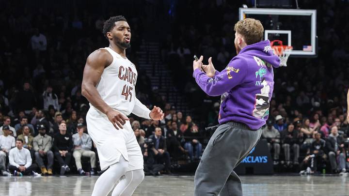 Oct 24, 2025; Brooklyn, New York, USA; A fan charges Cleveland Cavaliers guard Donovan Mitchell (45) on the court in the fourth quarter of the game between the Cleveland Cavaliers and the Brooklyn Nets at Barclays Center. Mandatory Credit: Wendell Cruz-Imagn Images Oct 24, 2025; Brooklyn, New York, USA; A fan charges Cleveland Cavaliers guard Donovan Mitchell (45) on the court in the fourth quarter of the game between the Cleveland Cavaliers and the Brooklyn Nets at Barclays Center. Mandatory Credit: Wendell Cruz-Imagn Images