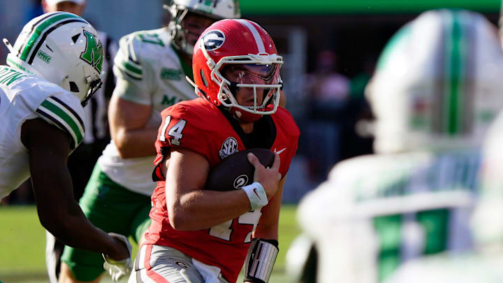 Georgia quarterback Gunner Stockton (14) runs the ball during the second half of a NCAA college football game against Marshall in Athens, Ga., on Saturday, August. 30, 2025. Georgia won 45-7.