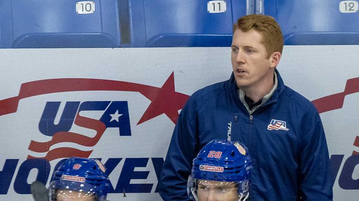 Aug 2, 2024; Plymouth, MI, USA; USA’s head coach Dave Carle watches the action from the bench against Sweden during the first period of the 2024 World Junior Summer Showcase at USA Hockey Arena. Mandatory Credit: David Reginek-Imagn Images Aug 2, 2024; Plymouth, MI, USA; USA’s head coach Dave Carle watches the action from the bench against Sweden during the first period of the 2024 World Junior Summer Showcase at USA Hockey Arena. Mandatory Credit: David Reginek-Imagn Images