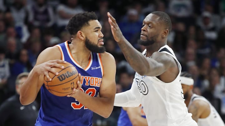 Dec 19, 2024; Minneapolis, Minnesota, USA; New York Knicks forward Karl-Anthony Towns (32) works around Minnesota Timberwolves forward Julius Randle (30) in the third quarter at Target Center. Mandatory Credit: Bruce Kluckhohn-Imagn Images