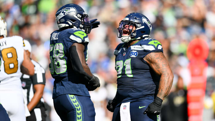 Sep 21, 2025; Seattle, Washington, USA; Seattle Seahawks defensive tackle Byron Murphy II (91) and linebacker Derick Hall (58) celebrate a sack against New Orleans Saints quarterback Spencer Rattler (2) during the third quarter at Lumen Field. 