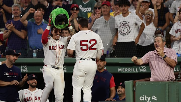 Jun 30, 2025; Boston, Massachusetts, USA; Boston Red Sox left fielder Jarren Duran (16) places the Wally helmet on right fielder Wilyer Abreu (52) after hitting an inside the park home run during the fifth inning against the Cincinnati Reds at Fenway Park. Mandatory Credit: Bob DeChiara-Imagn Images