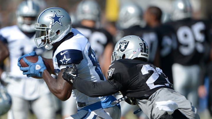 Aug 12, 2014; Oxnard, CA, USA; Dallas Cowboys receiver Dez Bryant (88) is defended by Oakland